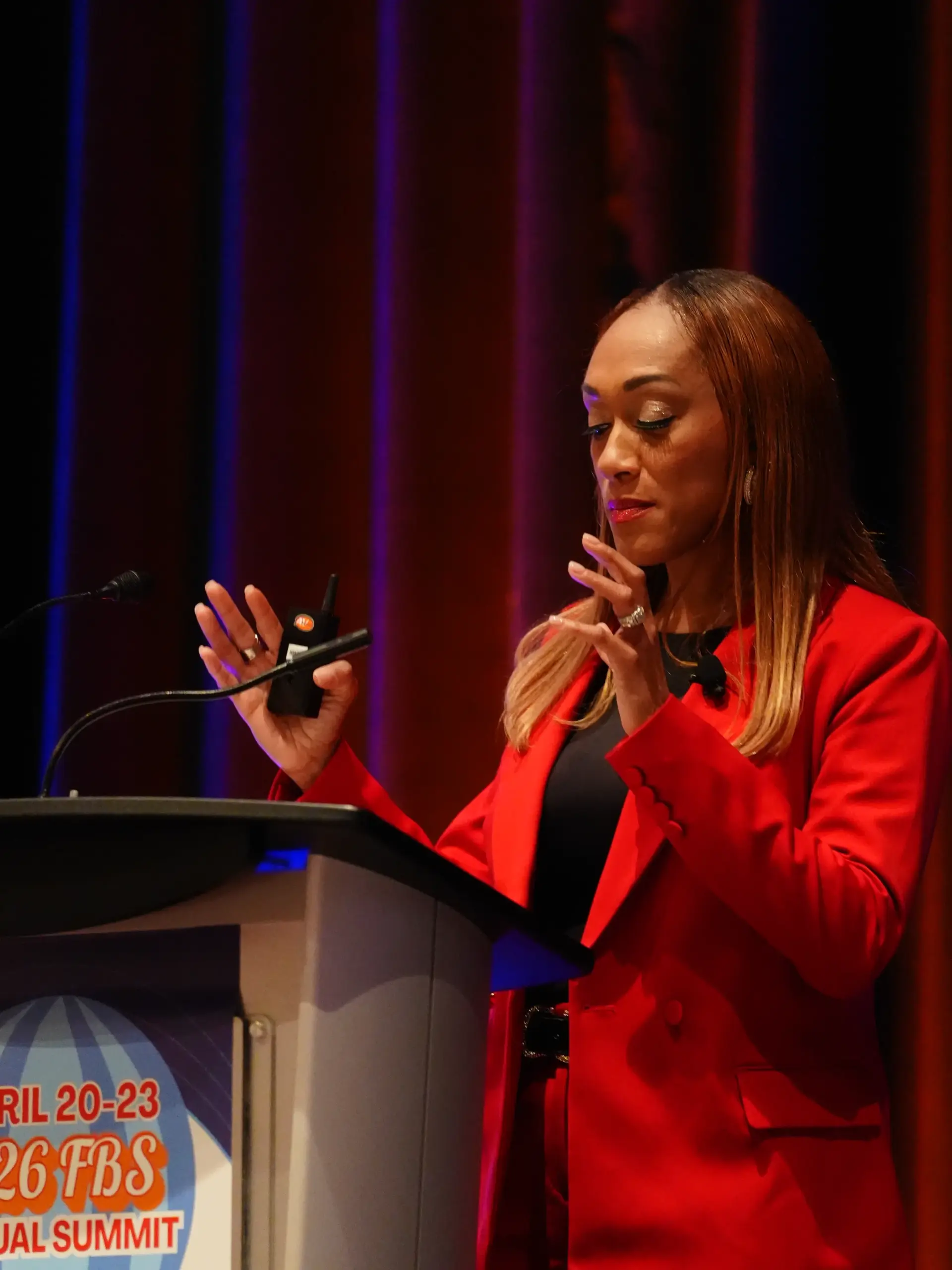 The NIL Doctor, Dr. Wendy Ellis Jones, at the FBS Summit Podium in Las Vegas, Nevada. Wendy gives a speech about NIL likeness, personal image, and athlete branding.